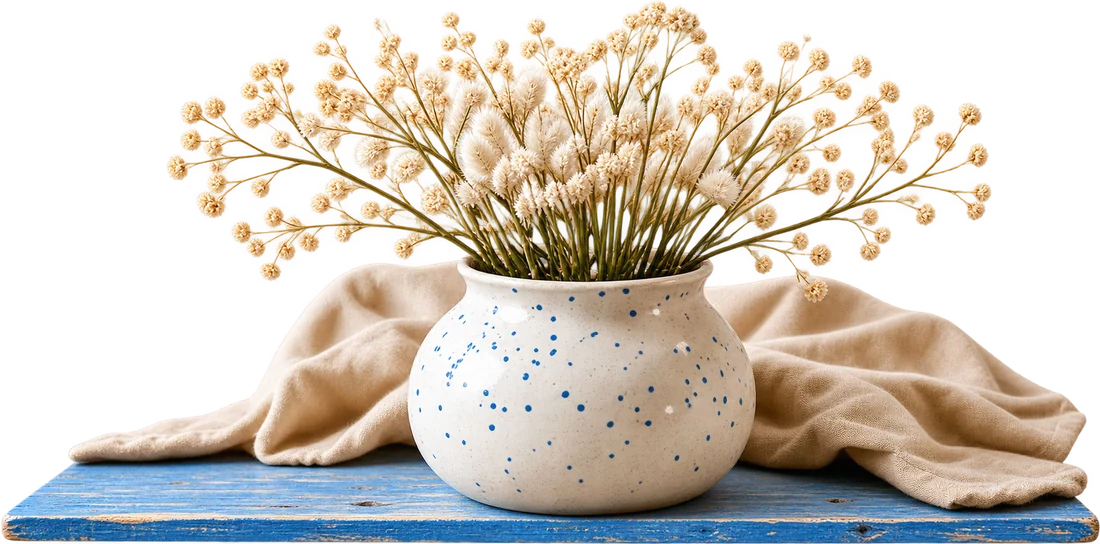 Dried flowers in a speckled ceramic vase